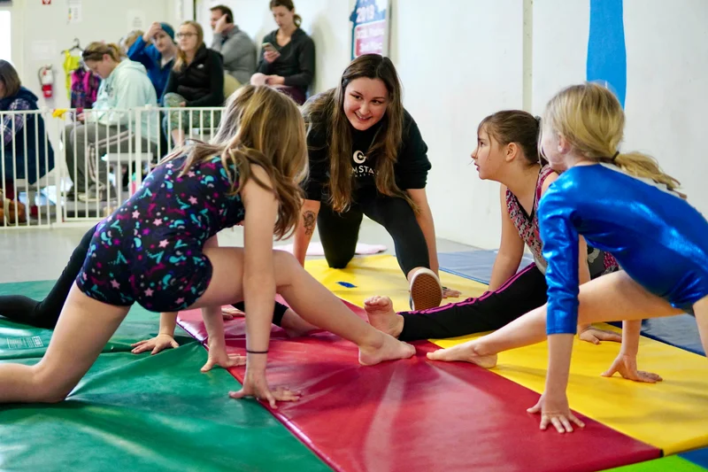 Families at a gymnastics academy front desk